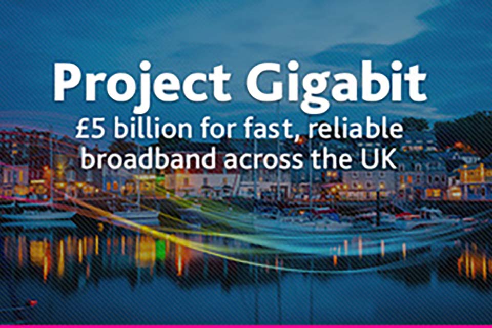 The logo for Project Gigabit, an exterior landscape shot of a city at nighttime.