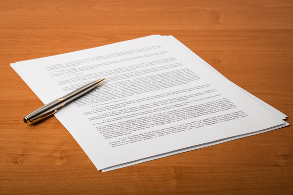 A manual on a desk with a pen.