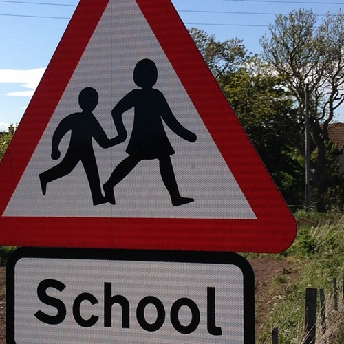 Road sign for a school ahead