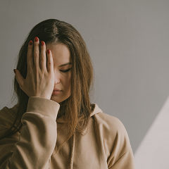 Photo of a woman with her hand on her face