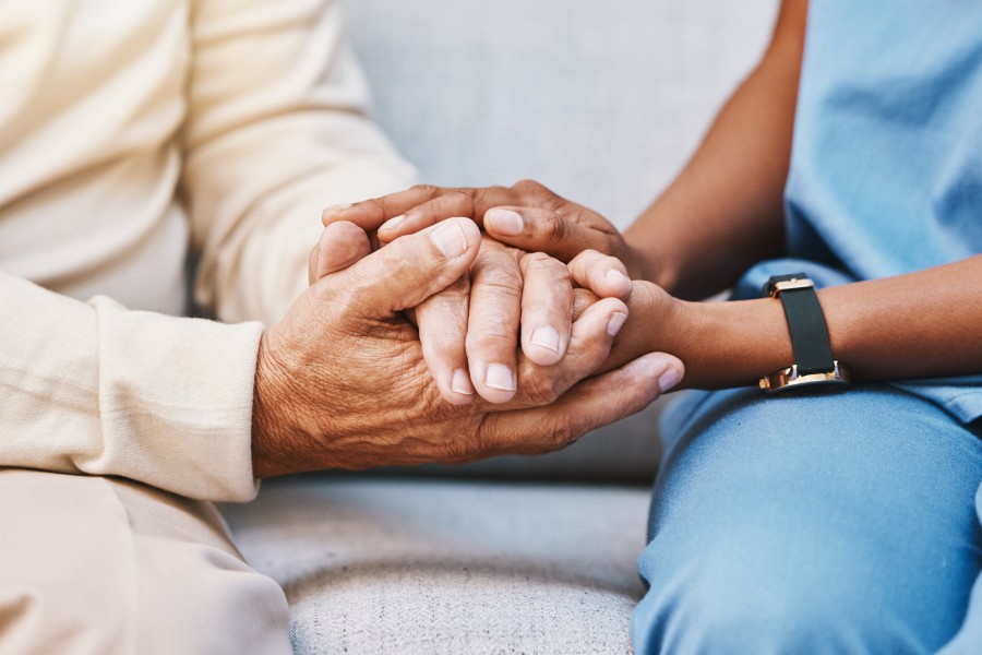 Image of two adults holding hands, focussed on the hands