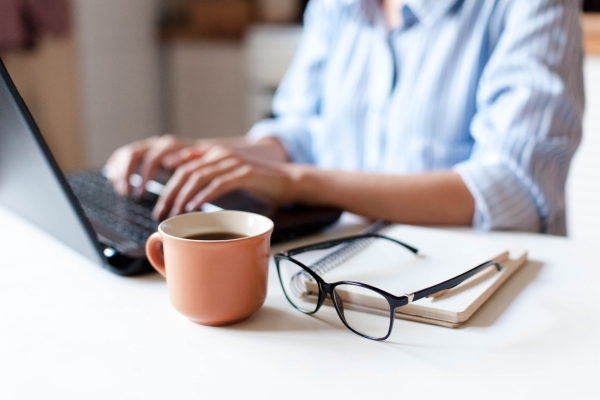 A image of someone completing documents on their laptop