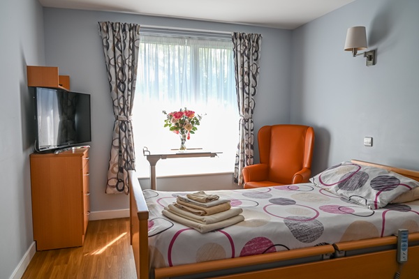 Care home bedroom with orange chair
