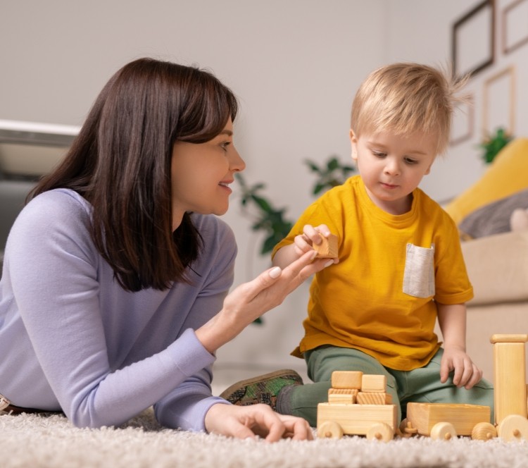 Mother and child playing with wooden toys