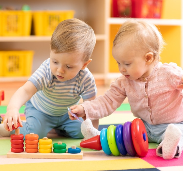 Two toddlers playing with toys