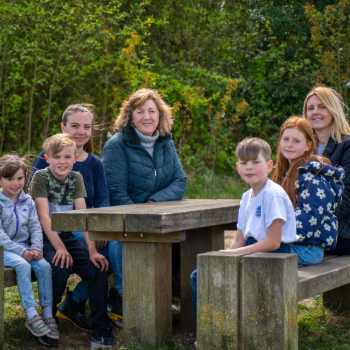 A group of children and foster carers sat at a picnic bench