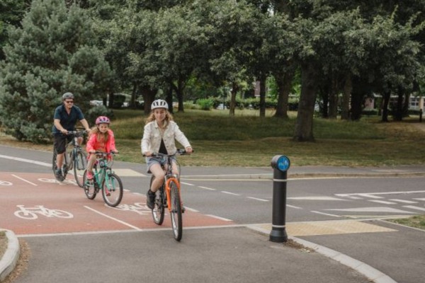 Family riding bikes along a cycle path