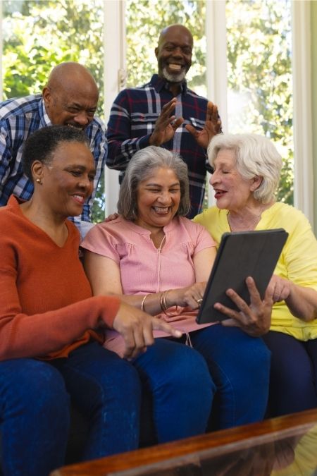 A group of people looking at something on a tablet
