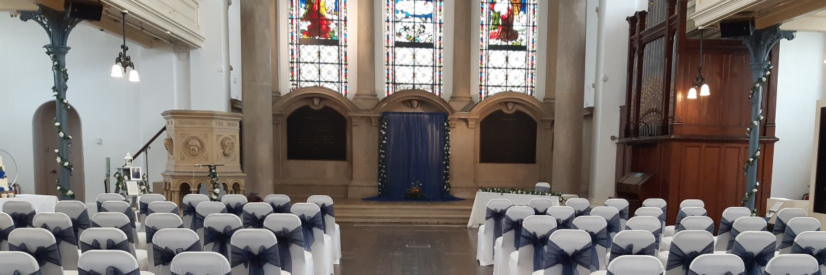 Internal shot of Royal Victoria Chapel at Royal Victoria Country Park with chairs and table set up for a wedding