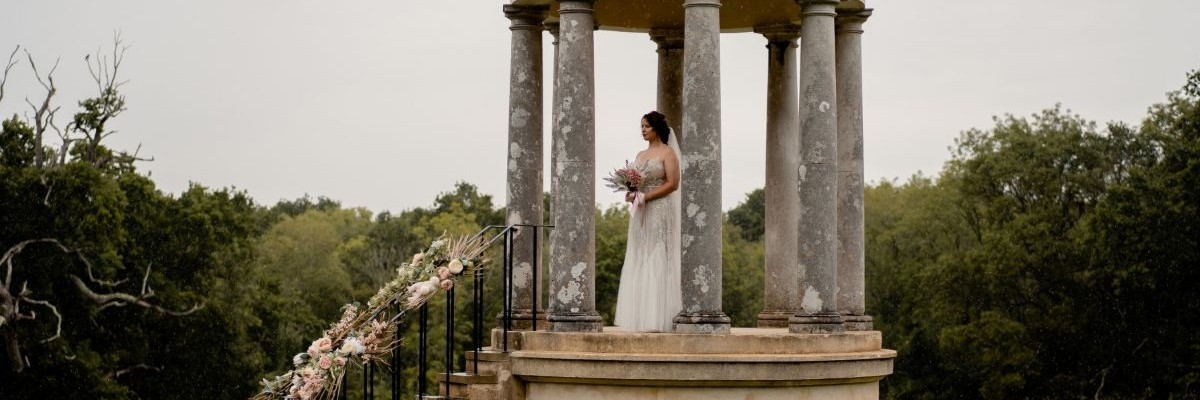 Bride standing in a stone archway