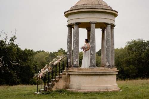 Bride standing inside a stone monument