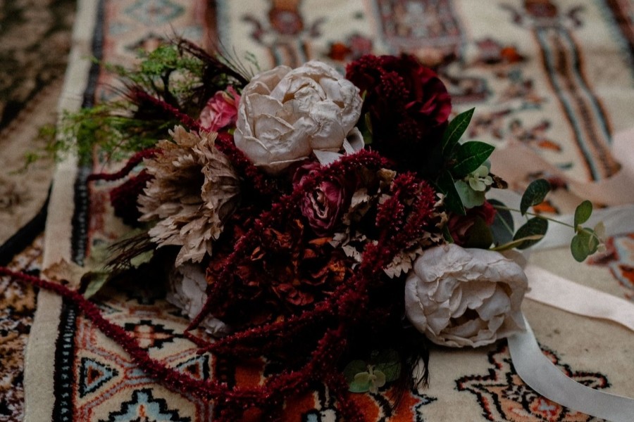 Display of two roses on a decorative rug