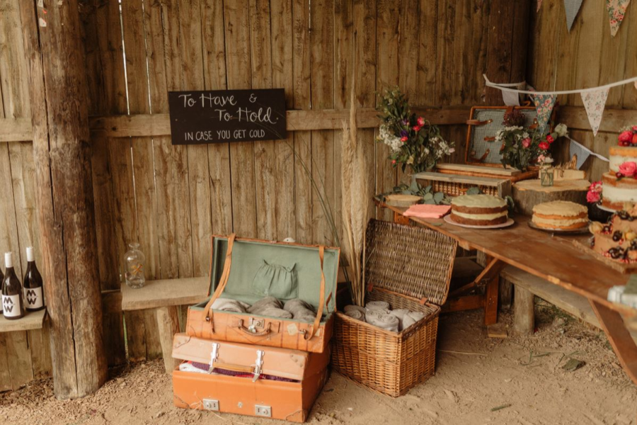 Variety of cakes on a table and a box of blankets