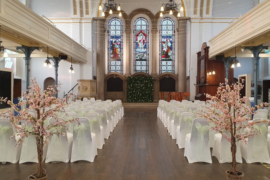 Internal shot of Royal Victoria Chapel at Royal Victoria Country Park with chairs and table set up for a wedding