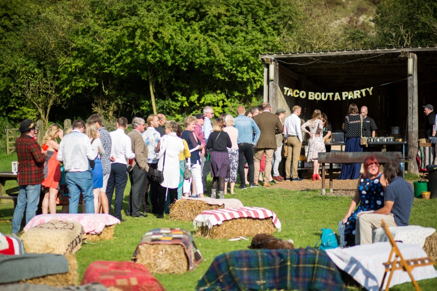 Guests queuing at an outdoor taco stand