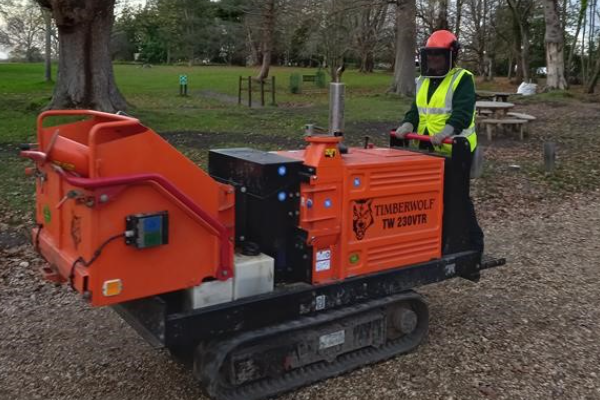 Someone using some machinery while doing countryside maintenance.