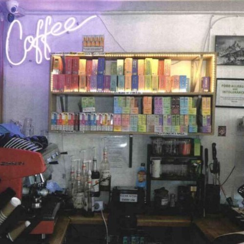 Interior of shop showing vapes on shelves.