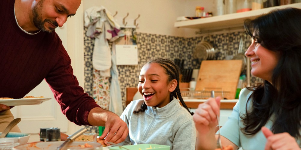 image shows foster family around the kitchen table
