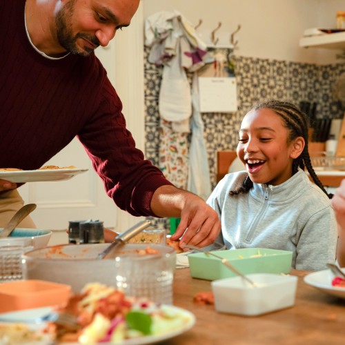 image shows foster family around the kitchen table