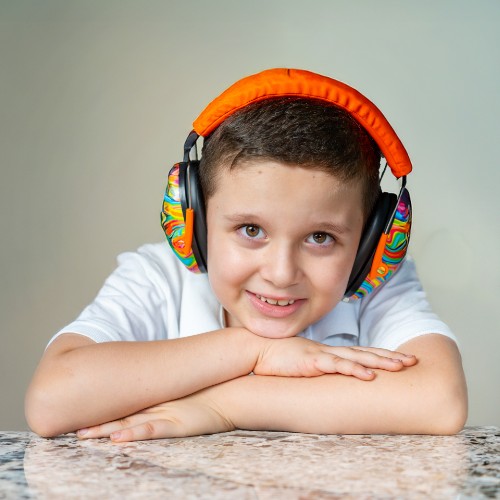 priary school-aged boy wearing noise-cancelling headphones