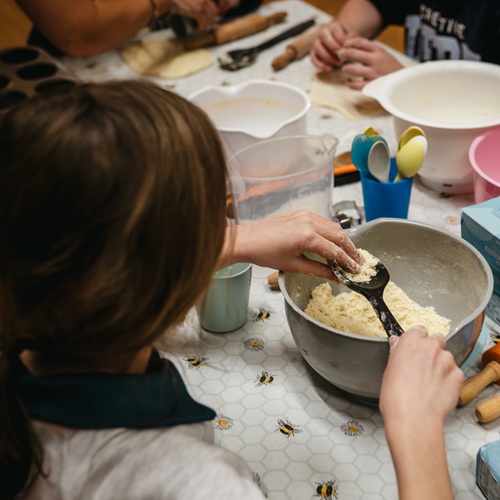 Child making food at a table
