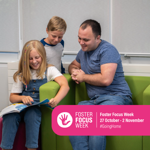 A young girl reads to another child and their carer. 
