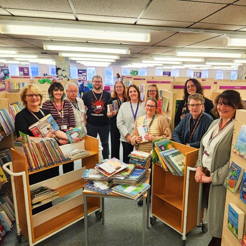 Photo shows members of the school library service in a library