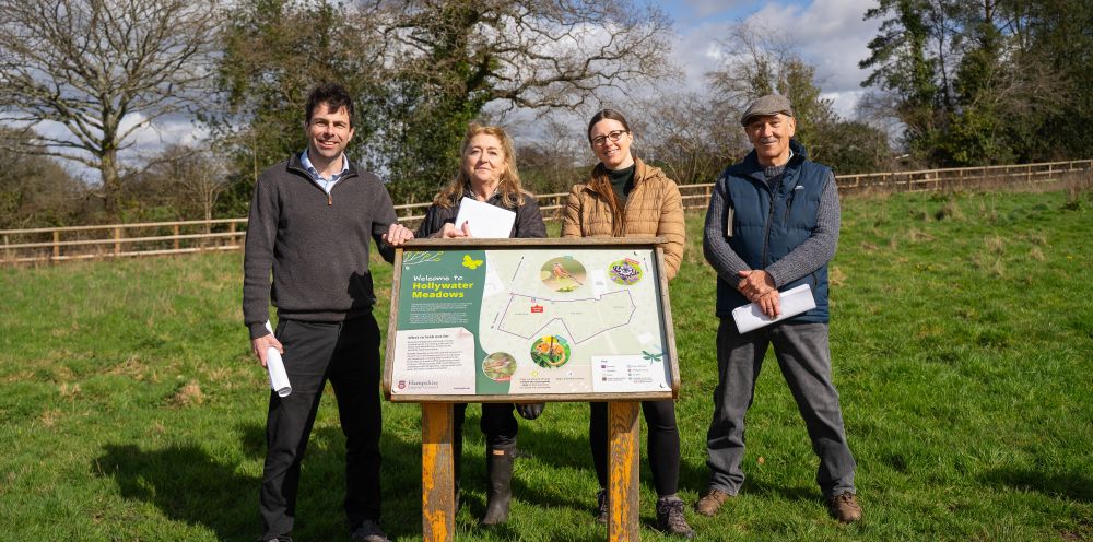 Image of Councillor Andy Tree, Councillor Debbie Curnow-Ford, Councillor Kirsty North, Councillor Mark Dickens behind an information board on Hollywater Meadows