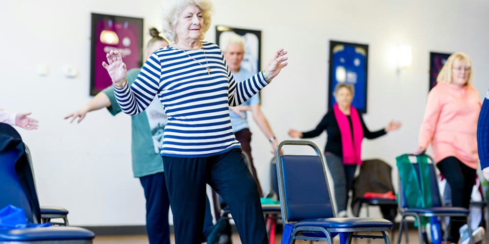 Older lady participating in a balance class
