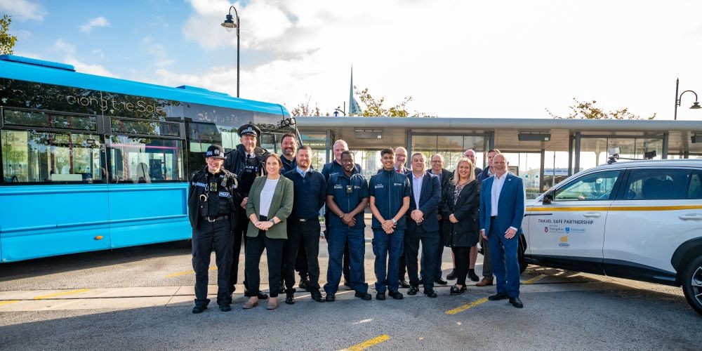 image of bus and TravelSafe vehicle with representatives from Police, partner councils and Travel Safe officers in the middle