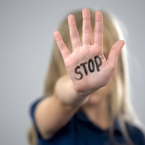 stop word on raised palm of hand