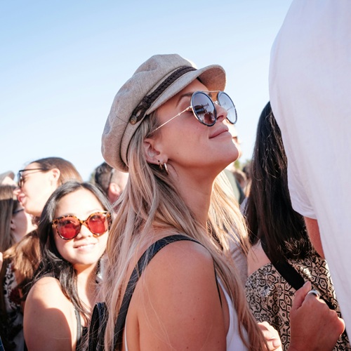 A girl at a music festival wearing sunglasses