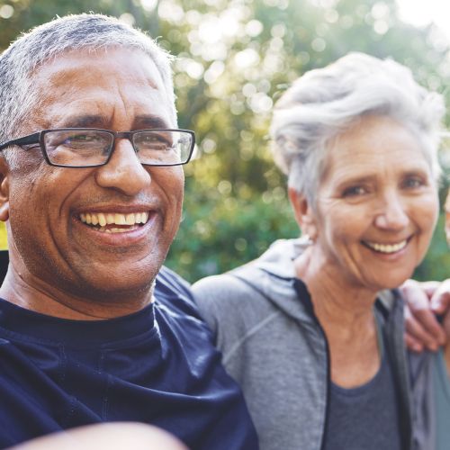 close up of a man and woman outdoors smiling 