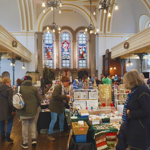 Picture of people browsing craft stalls inside the Royal Victoria Chapel, Netley