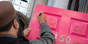 Imam signing the door