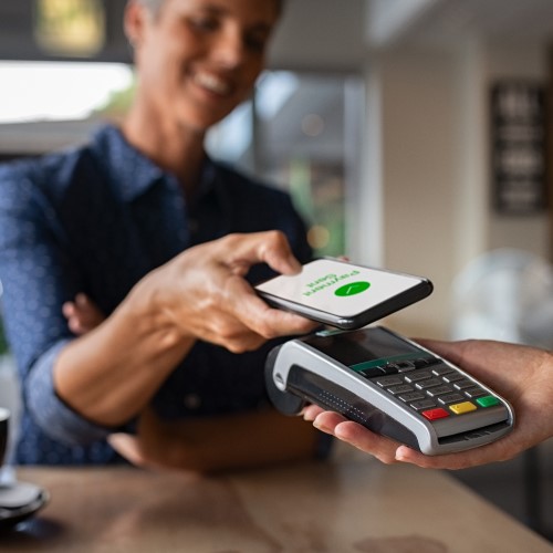 Person paying using contactless payment