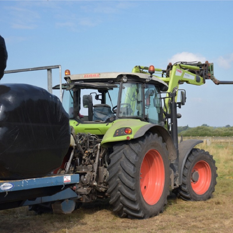 A green tractor in a field.