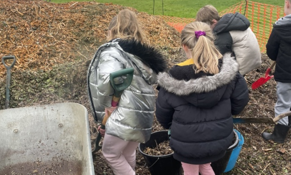 Children mulching a mini forest
