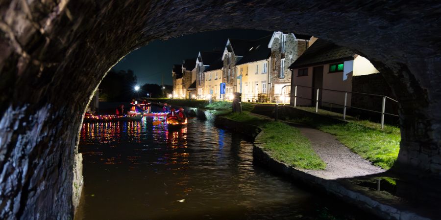 canoeists in the canal at night