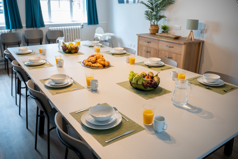 Dining table laid with crockery
