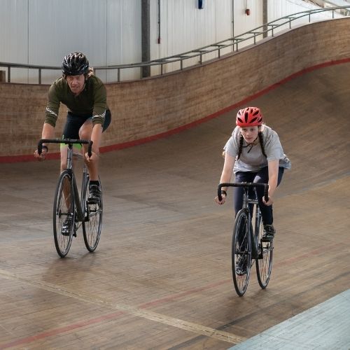 People riding bikes in the velodrome