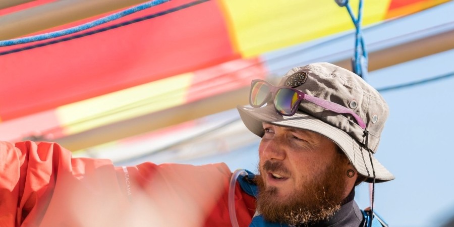 Bearded man with a hat on a sailing boat