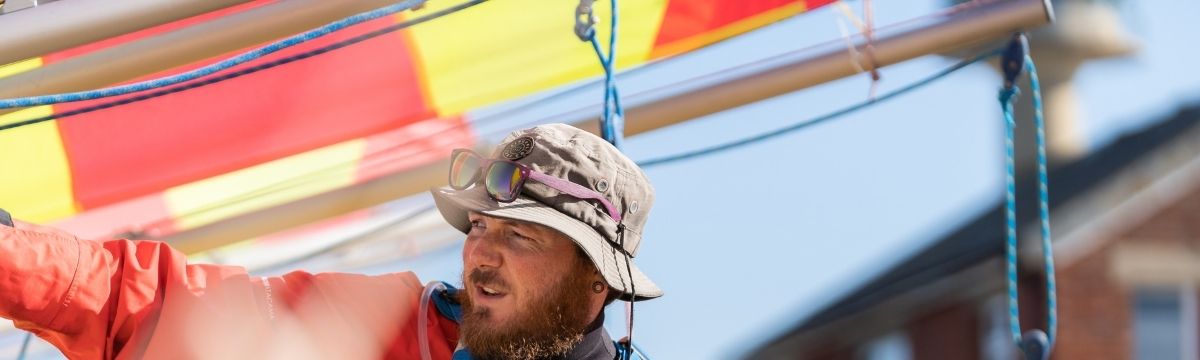 A man on a sailing boat