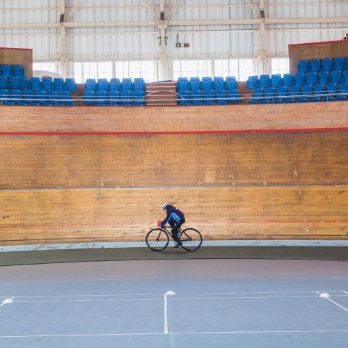 Boy cycling in the velodrome
