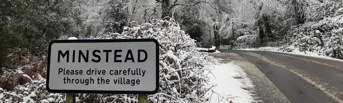 A Minstead village sign in the snow