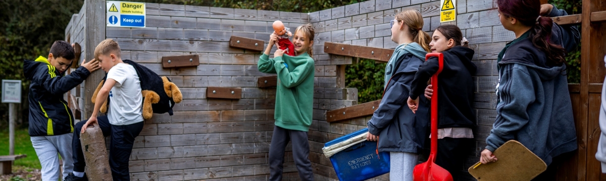 Children engaging in a teamwork activity in a simulated earthquake zone