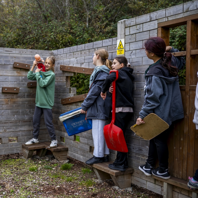 Children engaging in a teamwork activity in a simulated earthquake zone