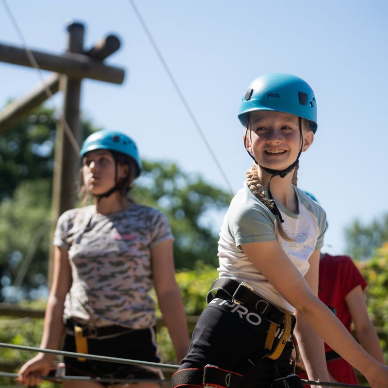 Two school-age children enjoying an outdoor activity on a sunny day