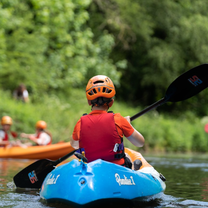 Young person paddling a kayak