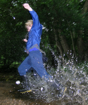 Child splashing in a puddle